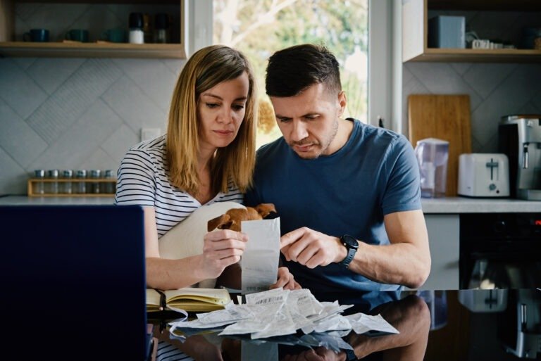 Man and woman looking at payment bills in the kitchen