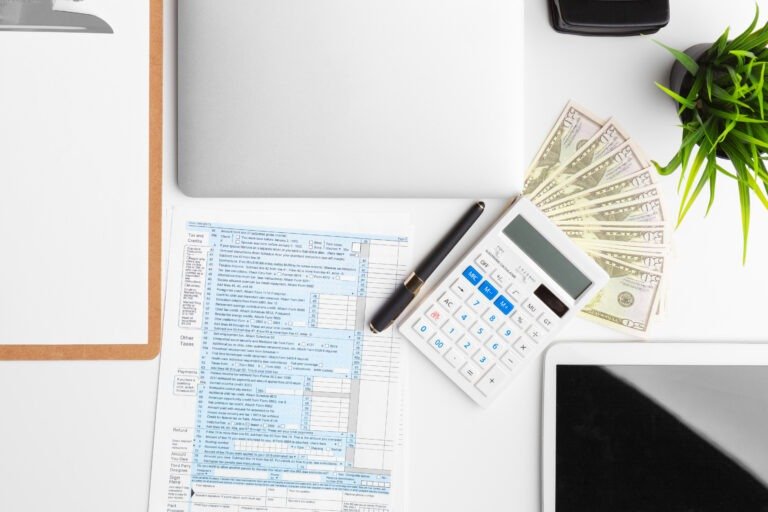 paperwork in the office and laptop on the desktop