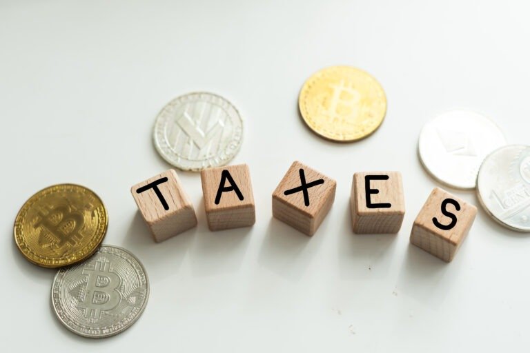 TAXES inscription on the texture of wooden cubes. Wooden cubes on the background of banknotes. An inscription on a financial, business or economic theme.