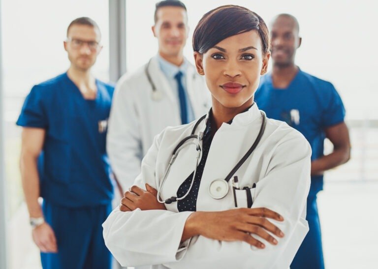 Black female doctor in front of team